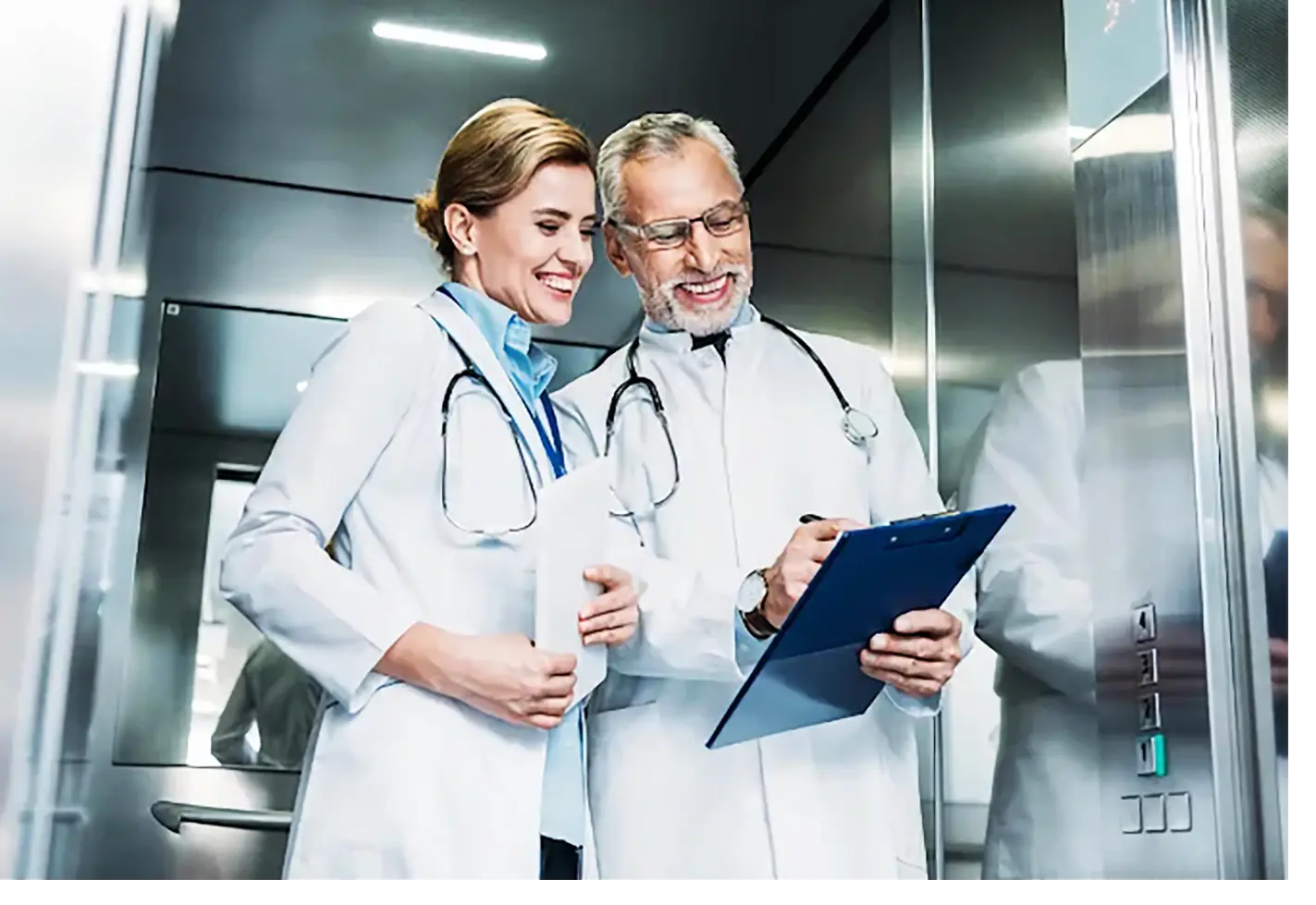 Silver-doored elevator with a white ceiling, serving as a hospital bed lift for transporting patients safely.